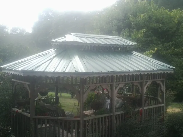 Two tier green metal roof on a garden gazebo in Ryde